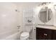 This bathroom has a tub-shower combination with white tile, a toilet, and vanity at 1545 W 7Th Ave, Mesa, AZ 85202