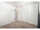 Well-lit bedroom with a ceiling fan, carpeted floors and double closets at 1545 W 7Th Ave, Mesa, AZ 85202