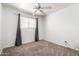 This carpeted bedroom includes a window, ceiling fan, and textured walls at 1545 W 7Th Ave, Mesa, AZ 85202