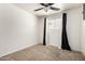 This cozy bedroom has plush carpeting, a window with blinds, and stylish curtains at 1545 W 7Th Ave, Mesa, AZ 85202