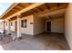 A covered carport featuring two support columns, painted ceilings and convenient access to the front door at 1545 W 7Th Ave, Mesa, AZ 85202