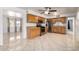 Bright kitchen featuring wooden cabinetry, tile flooring, stainless steel appliances, and backyard views at 1545 W 7Th Ave, Mesa, AZ 85202