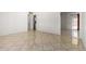 Spacious living room with tile flooring, white walls, and doorway views to the bathroom and backyard at 1545 W 7Th Ave, Mesa, AZ 85202