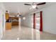 Open living space with tile flooring, white walls, a kitchen view, and a sliding door to the backyard at 1545 W 7Th Ave, Mesa, AZ 85202