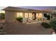 A charming covered patio boasts ample seating, perfect for relaxing or entertaining outdoors at 17653 W Ingleside Dr, Surprise, AZ 85374