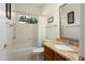 Bright bathroom features decorative, stained glass window, tile floors, shower over tub, and granite countertop sink at 17653 W Ingleside Dr, Surprise, AZ 85374