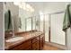 Bathroom featuring a double vanity with granite countertop and a glass-enclosed shower at 17653 W Ingleside Dr, Surprise, AZ 85374