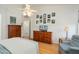 Bedroom with wood floors, a ceiling fan, and a collection of nature photos on the wall at 17653 W Ingleside Dr, Surprise, AZ 85374