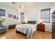 Cozy bedroom with wood floors, ceiling fan, and a window with outdoor views at 17653 W Ingleside Dr, Surprise, AZ 85374