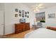 Bedroom featuring hardwood floors, a ceiling fan, dresser, and a window with outdoor view at 17653 W Ingleside Dr, Surprise, AZ 85374