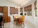 Bright dining area with a chandelier and large windows with backyard views at 17653 W Ingleside Dr, Surprise, AZ 85374