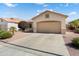 Inviting single-story home with a spacious driveway, neutral-toned exterior, tile roof, and low-maintenance landscaping at 17653 W Ingleside Dr, Surprise, AZ 85374