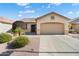Charming single-story home showcasing a two-car garage, neutral paint and low maintenance desert landscaping at 17653 W Ingleside Dr, Surprise, AZ 85374