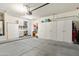 Spacious garage with ample built-in storage cabinets, workbench, and concrete floor, offering organized space at 17653 W Ingleside Dr, Surprise, AZ 85374