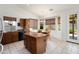Bright eat-in kitchen with granite counters, stainless steel appliances, wood cabinets, and a cozy breakfast nook at 17653 W Ingleside Dr, Surprise, AZ 85374