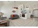 Spacious living room features tile flooring, neutral walls, a ceiling fan, and a fireplace with a built-in display shelf at 17653 W Ingleside Dr, Surprise, AZ 85374