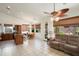 Cozy living area seamlessly integrates with the kitchen, featuring tile floors, warm lighting, and direct access to the backyard at 17653 W Ingleside Dr, Surprise, AZ 85374