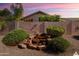 Backyard waterfall feature with lush landscaping and a peaceful ambiance at 17653 W Ingleside Dr, Surprise, AZ 85374
