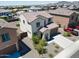 Aerial view of a tan two-story home featuring desert landscaping and a red pick-up truck at 19889 W Annika Dr, Litchfield Park, AZ 85340