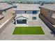 This backyard features an easily maintained desert landscaped yard with a patch of artificial turf at 19889 W Annika Dr, Litchfield Park, AZ 85340