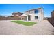 Exterior of home with low-maintenance gravel landscaping and an artificial turf area in the backyard at 19889 W Annika Dr, Litchfield Park, AZ 85340