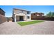 Spacious backyard featuring low-maintenance desert landscaping and a patch of artificial turf at 19889 W Annika Dr, Litchfield Park, AZ 85340