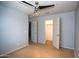 Spacious bedroom featuring modern ceiling fan, neutral walls, and convenient walk-in closet access at 19889 W Annika Dr, Litchfield Park, AZ 85340