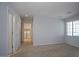 Bedroom featuring neutral paint, carpeting and laundry room access at 19889 W Annika Dr, Litchfield Park, AZ 85340