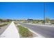 A wide street view features desert landscaping, sidewalks, and mountains in the distance at 19889 W Annika Dr, Litchfield Park, AZ 85340