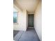 A covered home entry with a six-panel door at 19889 W Annika Dr, Litchfield Park, AZ 85340