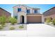 Charming two-story home featuring a stucco facade, tile roof, and a two-car garage at 19889 W Annika Dr, Litchfield Park, AZ 85340