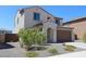 Inviting two-story home with desert landscaping, a private entry, and a two-car garage at 19889 W Annika Dr, Litchfield Park, AZ 85340
