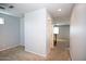 Carpeted hall leading to a staircase and a room with a ceiling fan at 19889 W Annika Dr, Litchfield Park, AZ 85340