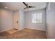 A well-lit room with carpet and a ceiling fan at 19889 W Annika Dr, Litchfield Park, AZ 85340