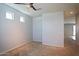 A carpeted room with a ceiling fan and a view to the hall at 19889 W Annika Dr, Litchfield Park, AZ 85340