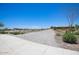 An open desert area with a gravel path provides a picturesque neighborhood view at 19889 W Annika Dr, Litchfield Park, AZ 85340