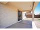 Covered patio with sliding glass door and textured stucco wall for outdoor relaxation at 19889 W Annika Dr, Litchfield Park, AZ 85340