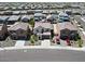 An aerial street view showcases neat homes with a red vehicle parked in the driveway at 19889 W Annika Dr, Litchfield Park, AZ 85340