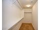 A well-organized walk-in closet with shelving and a clothing rod at 19889 W Annika Dr, Litchfield Park, AZ 85340