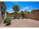 Backyard space with brick pavers, desert landscaping, and block wall fence at 21017 W Edith Way, Buckeye, AZ 85396