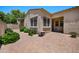 Private patio area with brick pavers, stucco walls, and well-maintained landscaping at 21017 W Edith Way, Buckeye, AZ 85396