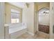 Soaking tub under a window with view to the outside at 21017 W Edith Way, Buckeye, AZ 85396