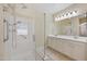 Beautiful bathroom features an updated, frameless shower and double vanity at 21017 W Edith Way, Buckeye, AZ 85396