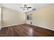 Bright bedroom with wood-look floors, a ceiling fan, and natural light from the windows at 21017 W Edith Way, Buckeye, AZ 85396