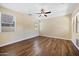 A bedroom with wood floors, a ceiling fan, and natural light from two windows at 21017 W Edith Way, Buckeye, AZ 85396