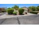 Attached garage with mature hedge rows, concrete driveway and tile roof at 21017 W Edith Way, Buckeye, AZ 85396