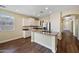 Open kitchen with white cabinets, granite countertops, stainless steel appliances, and center island at 21017 W Edith Way, Buckeye, AZ 85396