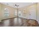 Bright living room with wood floors, multiple windows, and a ceiling fan for a welcoming space at 21017 W Edith Way, Buckeye, AZ 85396