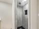 Tiled shower boasts modern hardware, a sleek dark-tiled accent and handy built-in niche at 2107 W Lane Ave, Phoenix, AZ 85021