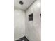Tiled shower boasts modern hardware, a sleek dark-tiled accent and handy built-in niche at 2107 W Lane Ave, Phoenix, AZ 85021